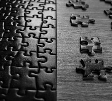 Interlocking puzzle pieces illustrating enterprise integration and connection of IT Infrastructures.