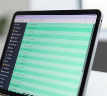 A close-up photograph of a sleek tablet screen displaying a vibrant digital leaderboard with glowing mint green and soft purple highlights in a modern, bright office setting. Global / English-speaking.