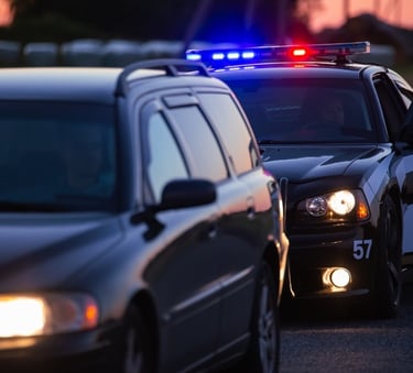 police car pulling over another car on the road