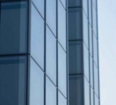 An abstract, sophisticated image of blue glass architectural lines reflecting a clear sky. The colors #4D6A7E and #B0C4D4 are prominent, symbolizing clarity and corporate structure.