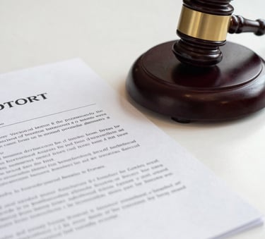 A close-up, high-detail photograph of a formal legal contract and a dark wood gavel on a stark white desk, reflecting a professional West African legal environment with sharp, focused lighting.