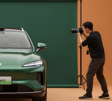 A high-end commercial photo shoot for a luxury vehicle. The photographer is adjusting a matte forest green (#224236) backdrop while the car is highlighted by warm, orange-tinted (#E06D28) studio lighting.