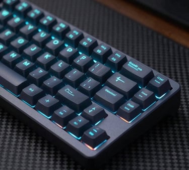 A close-up photograph of a sleek, dark mechanical keyboard with individual keys backlit in a vibrant cyan light, sitting on a carbon fiber desk in a dimly lit studio, Global / International.