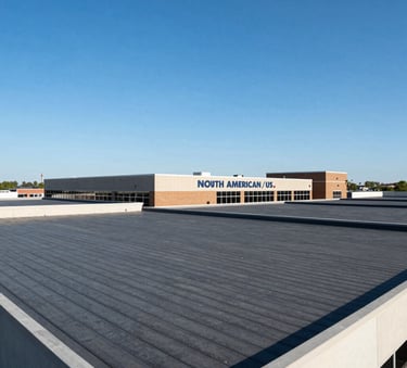 A wide angle shot of a commercial building in New Jersey with a perfectly finished dark gray flat roof under a bright blue sky, North American / US architecture.