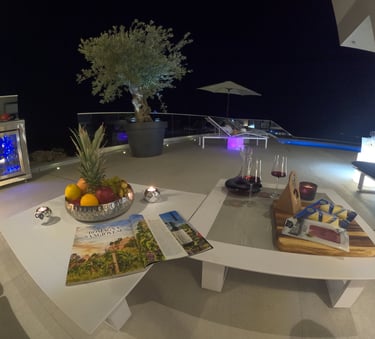 Villa Fay outdoor lounge at night with a glass of wine