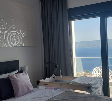 Villa Fay bedroom with a large bed and a view of the ocean