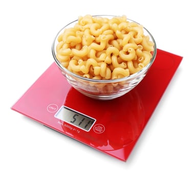 a food scale with a bowl of pasta