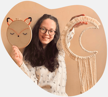 Mini Choum's : Créateur de décorations pour chambres d'enfant. Personne tenant une broderie totem re