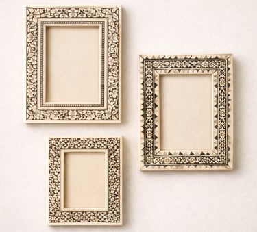 Bone photo frames with floral inlay designs and carved borders.