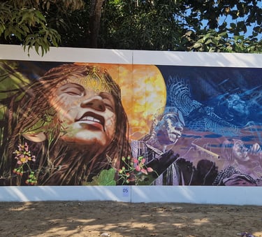 Vibrant outdoor mural featuring indigenous figures, a glowing moon, and a soaring eagle.