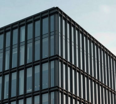 Minimalist architectural detail of a contemporary North American building facade, showing the intersection of glass and steel under a clear, soft sky. The composition is balanced and clean, evoking strategic structure.