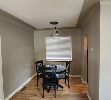 Residential interior painting in Denver featuring clean lines and neutral color palette in a dining 