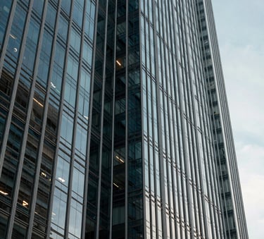 Abstract shot of a modern architectural building in a South American business district. Glass and steel structure reflecting a clear sky. Sophisticated, authoritative, and stable feel. Professional architectural photography.