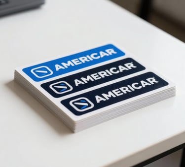 A stack of professionally printed branding stickers on a minimalist white table, showcasing vibrant electric blue and black colors in a North American design studio.