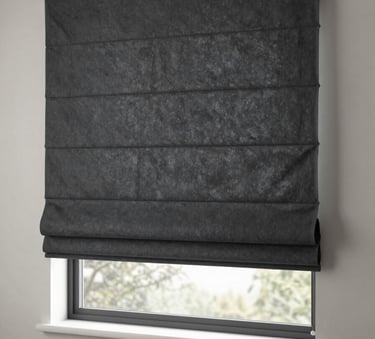 Clean, modern charcoal slate Roman shades perfectly fitted inside a large window frame in a North American bedroom. The lighting is calm and sophisticated, highlighting the crisp folds of the fabric.
