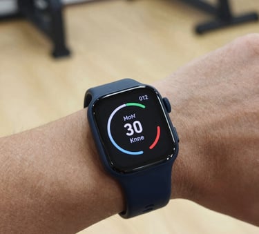 Macro photography of a premium fitness wearable on a wrist showing performance metrics. Deep navy blue and light beige tones in the background, captured in a high-end North American / Canadian gym setting.