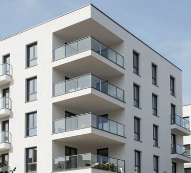 A modern residential real estate development in Central Europe, clean white facade, glass balcony, bright daylight.
