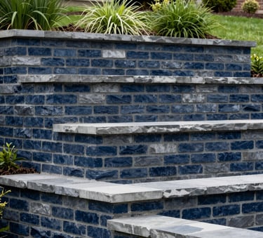 Professional architectural photograph of a multi-tiered retaining wall made of dark navy blue and slate grey bricks, integrated into a lush North American / US residential landscape.