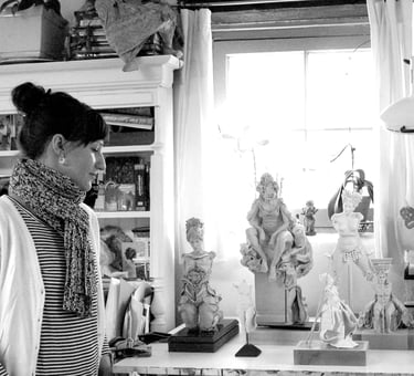 Artist Clea Carlsen in her studio with several finished sculptures.