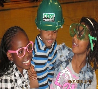 three young children wearing safety glasses and safety glasses