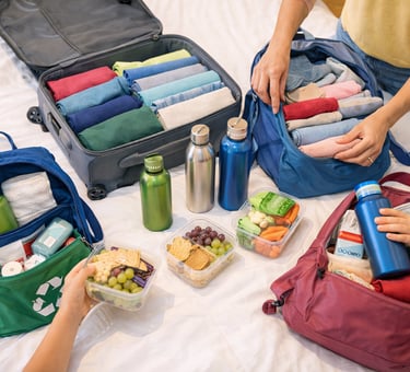 Sustainable travel packing with reusable bottles and snacks