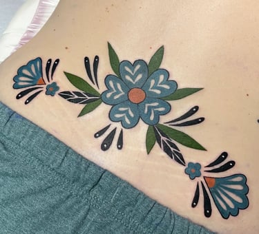 Lower back tattoo in retro ‘tramp stamp’ style done at Aura Tattoo Studios in Lewisville, TX