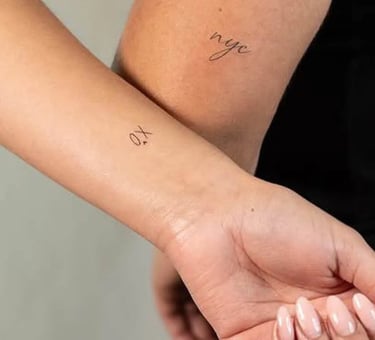 Minimal charm tattoos featuring small symbolic icons at Aura Tattoo Studios