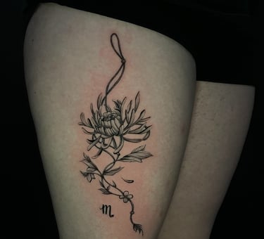 Elegant floral tattoo with fine line botanical details at Aura Tattoo Studios in Lewisville TX