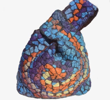 Handmade felted wool mosaic knot bag featuring a colorful stained glass pattern in blue, purple, and orange.