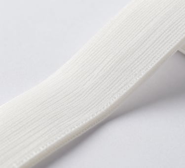 Spools of knitting yarn in rich hues displayed against a sleek black background.