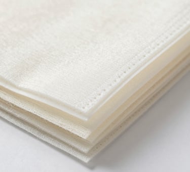 Close-up of soft, colorful hand knitting yarns neatly arranged in skeins.