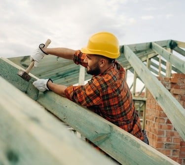 a man in a hard hat working on a roof