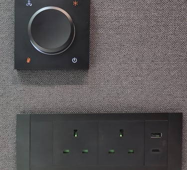 Power outlet panel with dial switch on felt wall