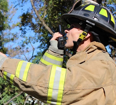 Firefighter observing a critical situation while reporting it via his S380 PoC radio