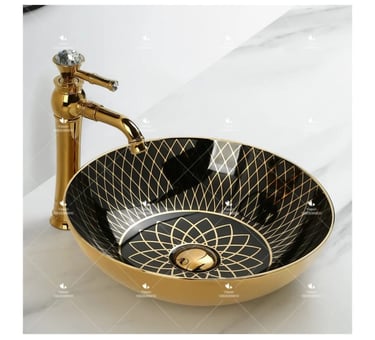 a bathroom sink with a gold sink and a faucet faucet