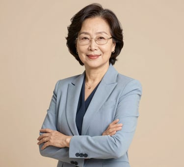 A smiling woman sitting at her laptop, engaged in an online English lesson.