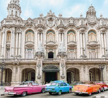 Classic cars parked in front of a building in Havana, Cuba