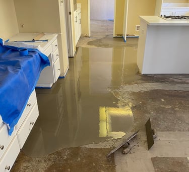 a kitchen floor with a blue tarp and a blue tarp
