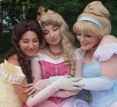 Belle, Cinderella, and Aurora share a hug
