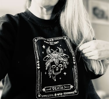 a tarot design sweater, white thread on a black sweater