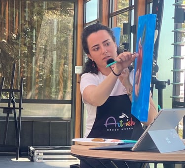 an artist instructing a painting session