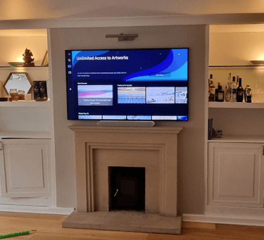 Professional TV wall mounting service. TV on wall above a fireplace