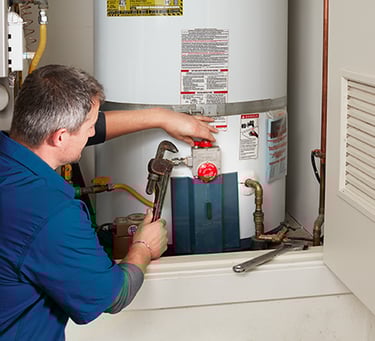 Certified plumber installing water heater in Dubai home for reliable hot water