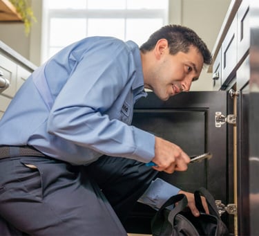 Plumber using advanced leak detection equipment to fix water leak in Dubai home