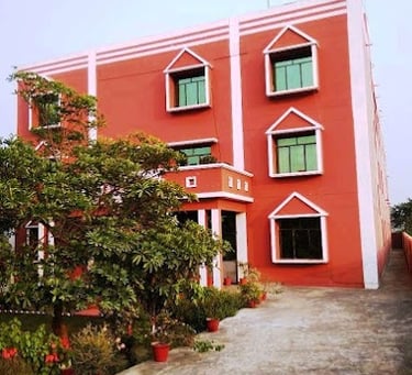 a red building with a tree in the foreground