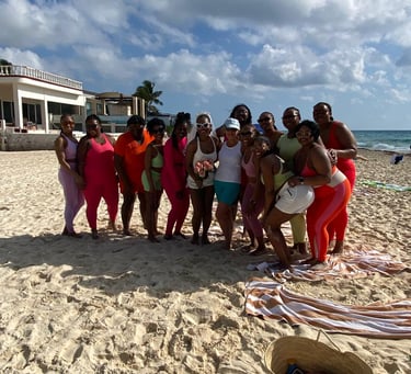 a group of people standing on a beach after Yoga on the beach Playa del carmen