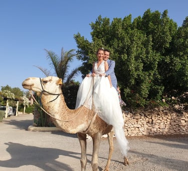 a man and woman are riding on a camel