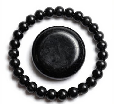 Handcrafted decorative stone disk with black and white rings surrounded by polished agate beads.