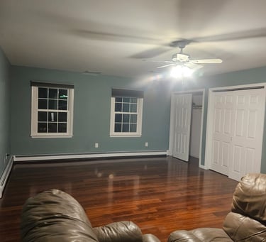 a living room with a couch and  new flooring installation.