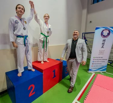 2024 Hwa Rang Tournament Winners on Podium with Master Carlos Bazan